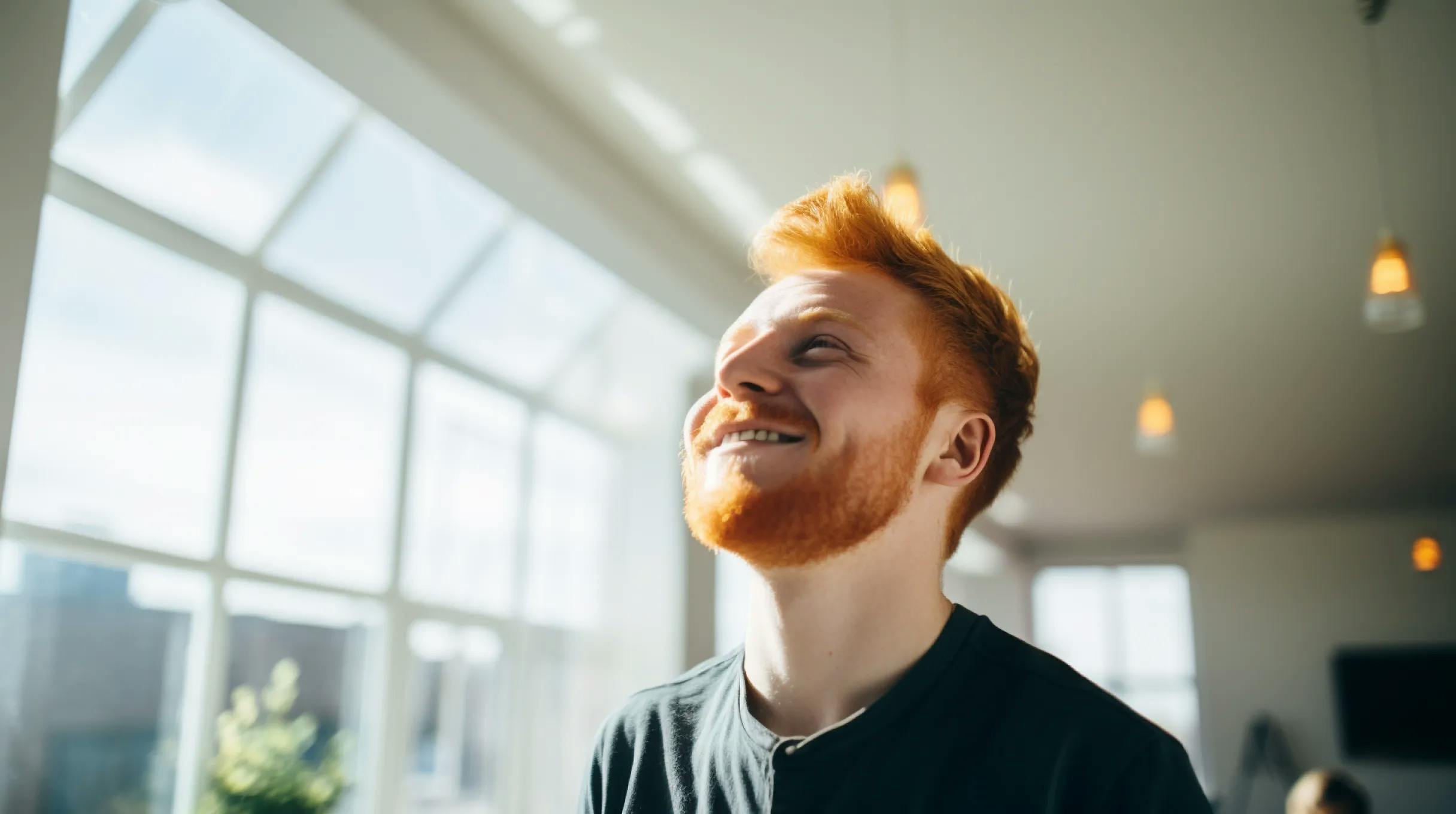 A smiling man with red hair and a beard.